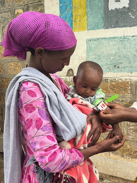 A mother and child supported through food rations in Ethiopia