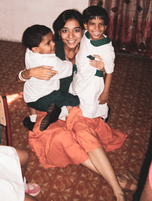 Tanya Pinto volunteering with two children at Shishu Bhavan orphanage in Kolkata